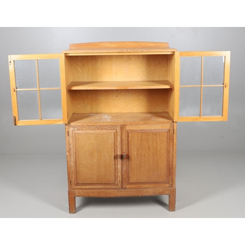 556 - BRYNMAWR FURNITURE - OAK DISPLAY CABINET. An oak display cabinet with a glazed top section with a si... 