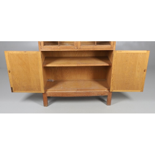 556 - BRYNMAWR FURNITURE - OAK DISPLAY CABINET. An oak display cabinet with a glazed top section with a si... 