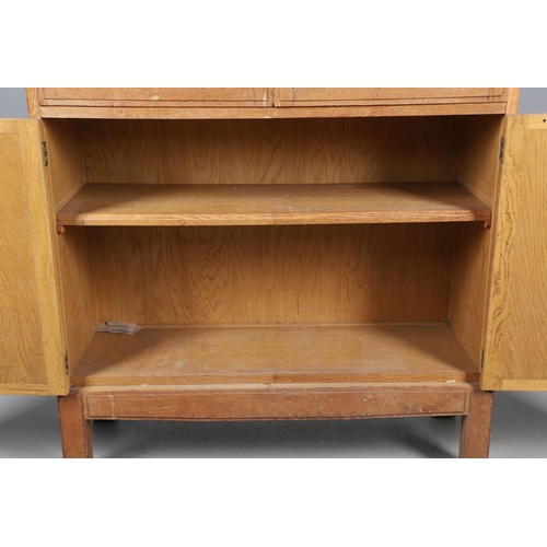 556 - BRYNMAWR FURNITURE - OAK DISPLAY CABINET. An oak display cabinet with a glazed top section with a si... 