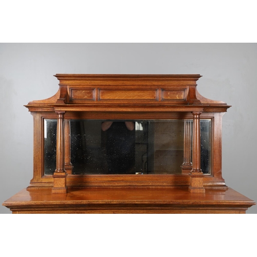 557 - ARTS & CRAFTS OAK MIRROR BACK SIDEBOARD. A large Arts & Crafts oak sideboard with a mirror back, the... 