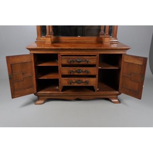 557 - ARTS & CRAFTS OAK MIRROR BACK SIDEBOARD. A large Arts & Crafts oak sideboard with a mirror back, the... 