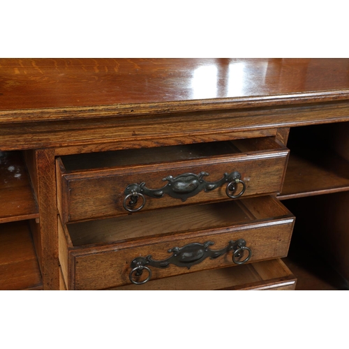 557 - ARTS & CRAFTS OAK MIRROR BACK SIDEBOARD. A large Arts & Crafts oak sideboard with a mirror back, the... 