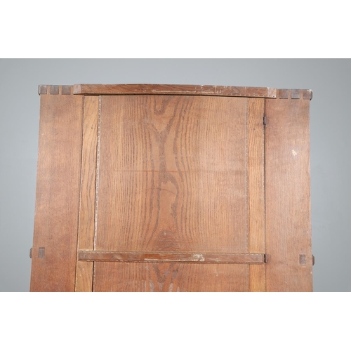 559 - A COTSWOLD SCHOOL ARTS AND CRAFTS OAK WARDROBE BY ERNEST GIMSON. A large and impressive oak Cotswold... 