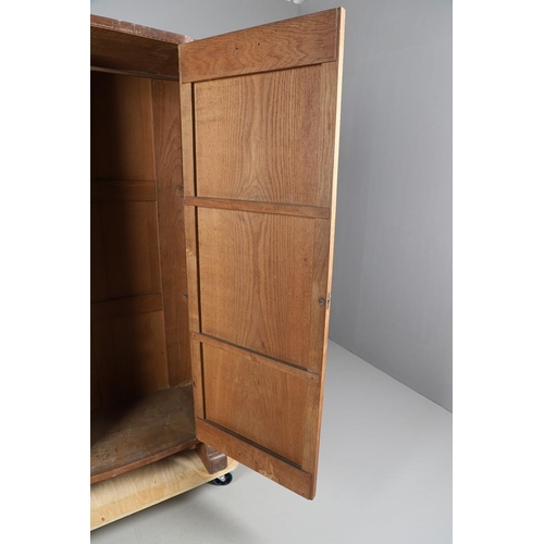 559 - A COTSWOLD SCHOOL ARTS AND CRAFTS OAK WARDROBE BY ERNEST GIMSON. A large and impressive oak Cotswold... 