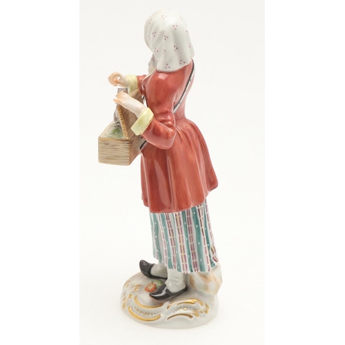 597 - TWO MEISSEN PORCELAIN FIGURES. Including a porcelain figure of a lady holding a box with small anima... 