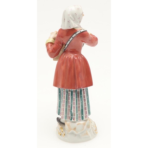 597 - TWO MEISSEN PORCELAIN FIGURES. Including a porcelain figure of a lady holding a box with small anima... 