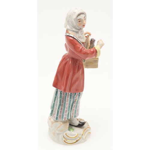 597 - TWO MEISSEN PORCELAIN FIGURES. Including a porcelain figure of a lady holding a box with small anima... 