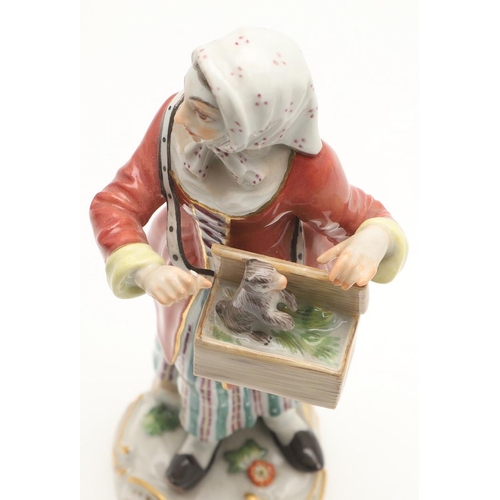 597 - TWO MEISSEN PORCELAIN FIGURES. Including a porcelain figure of a lady holding a box with small anima... 