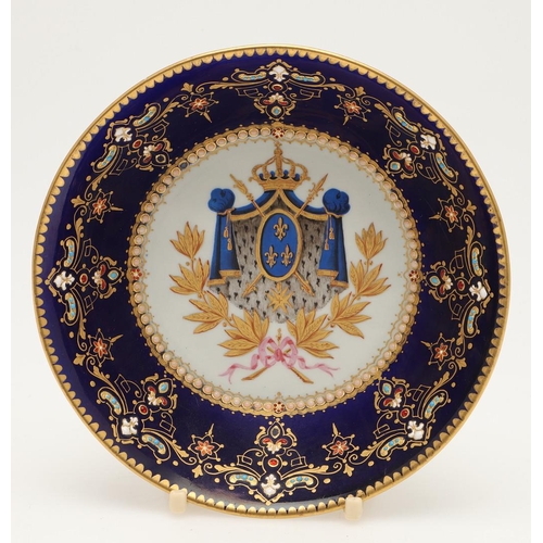 600 - A SEVRES STYLE BLUE GROUND JEWELLED CABINET CUP AND SAUCER. late 19th century, the cup painted with ... 