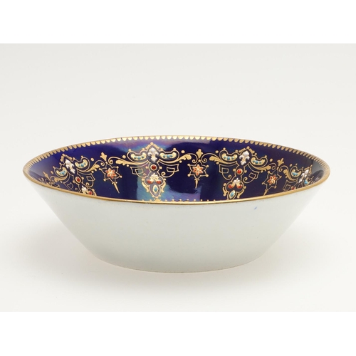 600 - A SEVRES STYLE BLUE GROUND JEWELLED CABINET CUP AND SAUCER. late 19th century, the cup painted with ... 