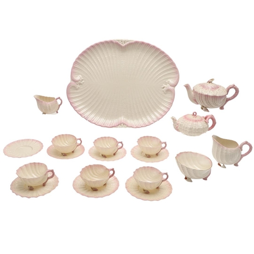 604 - BELLEEK TRAY & TEA SERVICE. A large shell shaped tray with a pink coloured rim (41.5cms across), als... 