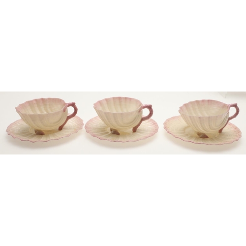 604 - BELLEEK TRAY & TEA SERVICE. A large shell shaped tray with a pink coloured rim (41.5cms across), als... 