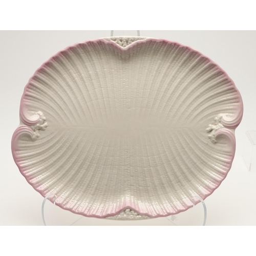 604 - BELLEEK TRAY & TEA SERVICE. A large shell shaped tray with a pink coloured rim (41.5cms across), als... 