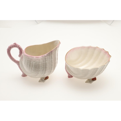 604 - BELLEEK TRAY & TEA SERVICE. A large shell shaped tray with a pink coloured rim (41.5cms across), als... 