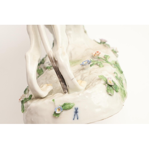 608 - MEISSEN STYLE PORCELAIN GREYHOUND. A Meissen style figure of a running Greyhound, the oval shaped ba... 