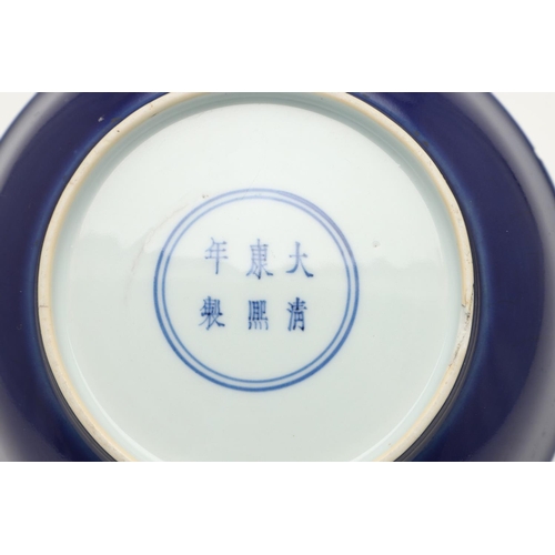 626 - CHINESE KANGXI MONOCHROME DISH. Kangxi mark and period (1662-1722), a blue glazed circular dish, the... 