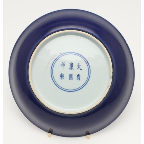 626 - CHINESE KANGXI MONOCHROME DISH. Kangxi mark and period (1662-1722), a blue glazed circular dish, the... 