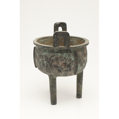 631 - A CHINESE BRONZE ARCHAISTIC STYE BRONZE VESSEL, DING. Probably 20thc, the cup shaped bowl with twin ... 