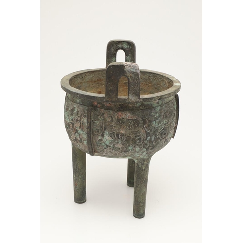 631 - A CHINESE BRONZE ARCHAISTIC STYE BRONZE VESSEL, DING. Probably 20thc, the cup shaped bowl with twin ... 