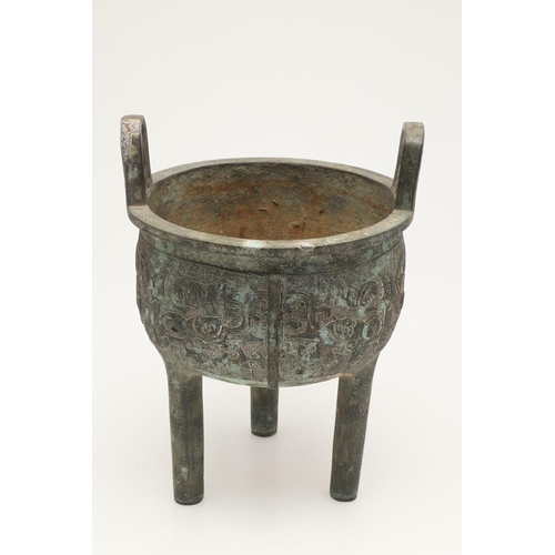 631 - A CHINESE BRONZE ARCHAISTIC STYE BRONZE VESSEL, DING. Probably 20thc, the cup shaped bowl with twin ... 