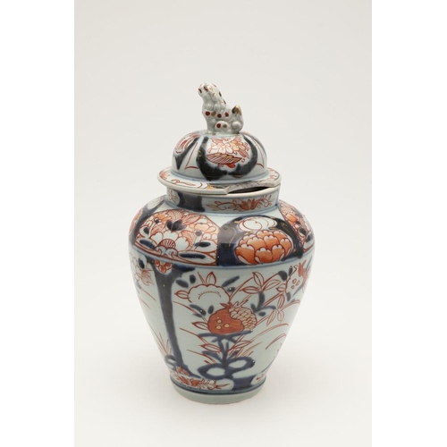 632 - A PAIR OF 19THC JAPANESE IMARI LIDDED JARS. A pair of 19thc Imari lidded jars, with a tapering round... 