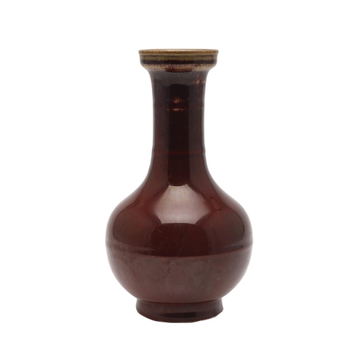 660 - CHINESE 19THC SANG DE BOEUF VASE. A 19thc bottle shaped vase, with a copper red glaze to the body an... 