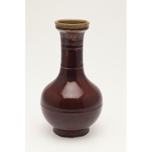 660 - CHINESE 19THC SANG DE BOEUF VASE. A 19thc bottle shaped vase, with a copper red glaze to the body an... 