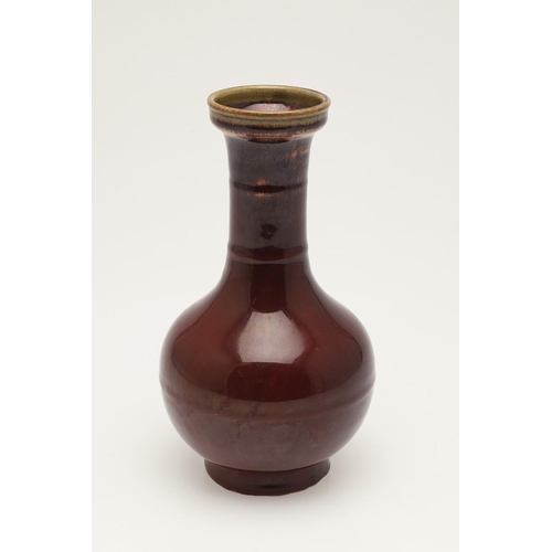 660 - CHINESE 19THC SANG DE BOEUF VASE. A 19thc bottle shaped vase, with a copper red glaze to the body an... 