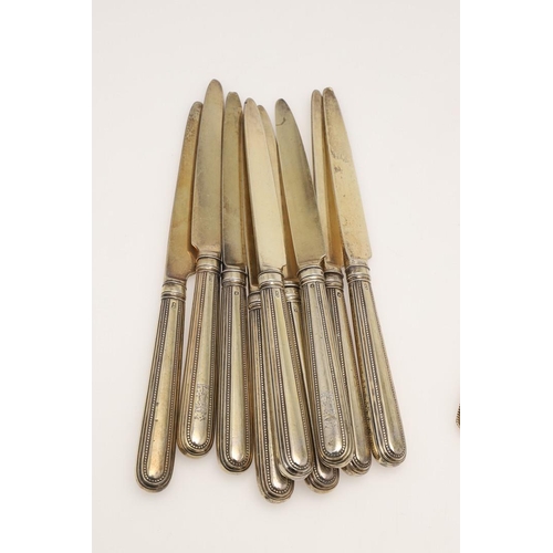 1 - A GEORGE III PART-SERVICE OF SILVERGILT FLATWARE. 18 dessert forks & 18 dessert spoons in Old Englis... 