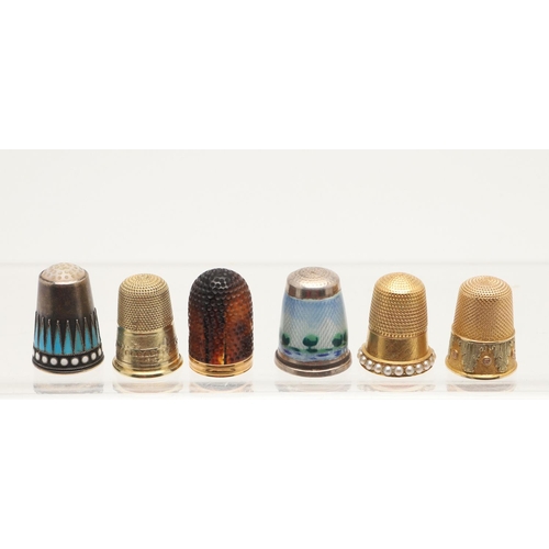 123 - SIX THIMBLES. three gold examples (one three-tone, one with seed pearls and another depicting a brid... 