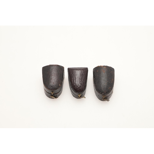 125 - THREE CASED GOLD THIMBLES. one with a panelled body & engraved decoration, one with a plain body and... 