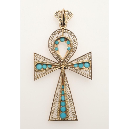 153 - A TURQUOISE AND GOLD CRUCIFORM PENDANT. the gold filigree mounted set with graduated turquoise caboc... 