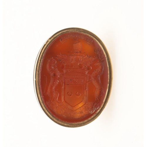 156 - A GOLD AND CARNELIAN SEAL. with fluted body, the oval-shaped carnelian engraved with the crest of th... 