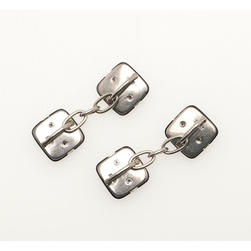 160 - A PAIR OF BLACK ONYX AND DIAMOND CUFFLINKS. each 18ct white gold and black onyx link set with a link... 