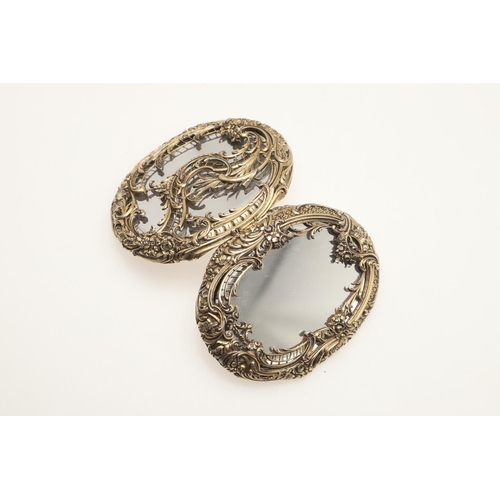 163 - A SILVER GILT COMPACT MIRROR BY BOUCHERON. of oval-shape, each mirrored side enclosed by foliate and... 