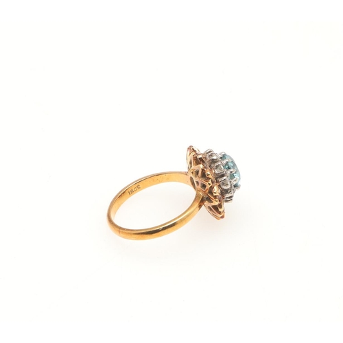 203 - A ZIRCON AND DIAMOND CLUSTER RING. the circular-cut zircon is set within a double surround of circul... 