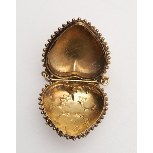 209 - A REGENCY REGARD HEART SHAPED LOCKET PENDANT. with fruiting vine decoration to the front, with gem s... 