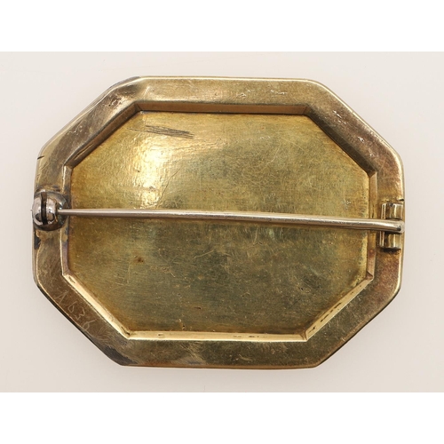 212 - A 19TH CENTURY GOLD AND GREEN GLASS BROOCH. set with a hexagonal foil backed green glass panel mount... 