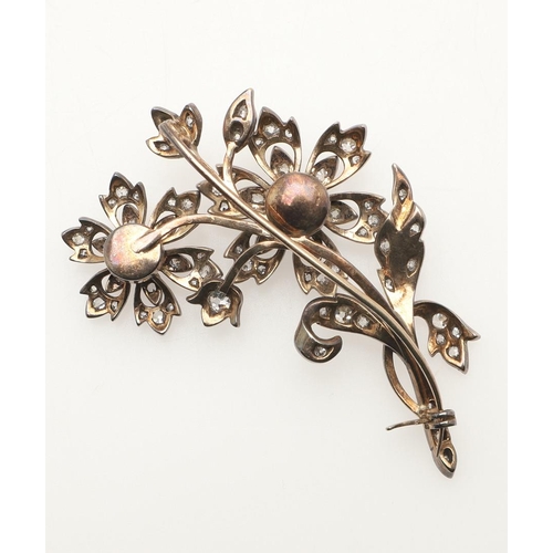 217 - A VICTORIAN DIAMOND FOLIATE SPRAY BROOCH. the two flowerheads set en tremblant, mounted overall with... 