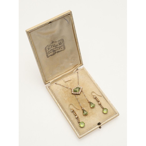 229 - AN EDWARDIAN PERIDOT AND PEARL DROP PENDANT. the central peridot is set within a surround of half pe... 