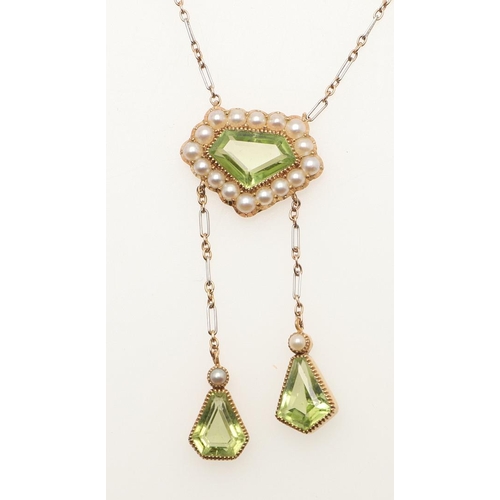 229 - AN EDWARDIAN PERIDOT AND PEARL DROP PENDANT. the central peridot is set within a surround of half pe... 