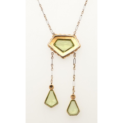 229 - AN EDWARDIAN PERIDOT AND PEARL DROP PENDANT. the central peridot is set within a surround of half pe... 