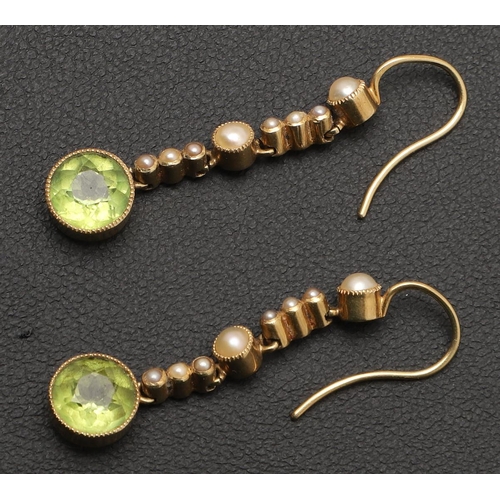 229 - AN EDWARDIAN PERIDOT AND PEARL DROP PENDANT. the central peridot is set within a surround of half pe... 