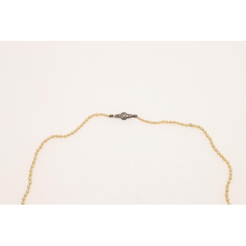 238 - A SINGLE ROW NATURAL PEARL NECKLACE. the pearls graduate from approximately 1.6 to 3.2mm to a clasp ... 