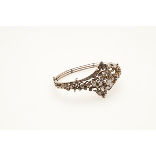 248 - A DIAMOND AND GOLD HALF HINGED BANGLE. the central cluster mounted with rose-cut diamonds and overal... 