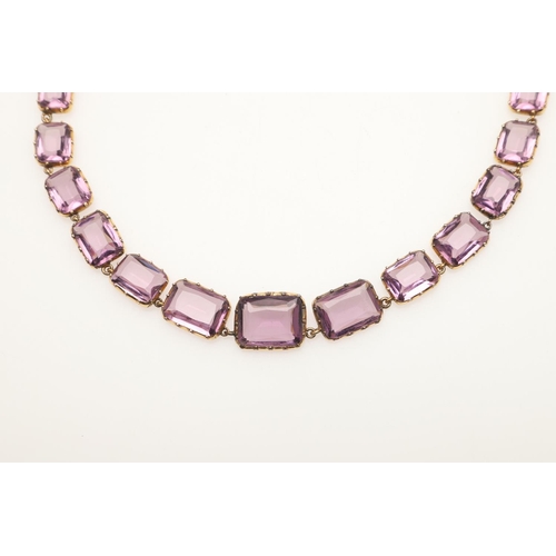 249 - AN VICTORIAN AMETHYST RIVIERE NECKLACE. mounted with graduated rectangular-shaped amethysts, in gold... 