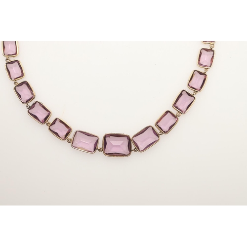 249 - AN VICTORIAN AMETHYST RIVIERE NECKLACE. mounted with graduated rectangular-shaped amethysts, in gold... 