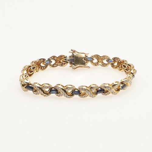 258 - A SAPPHIRE AND DIAMOND BRACELET. formed with marquise-cut sapphires, each divided by a diamond set c... 