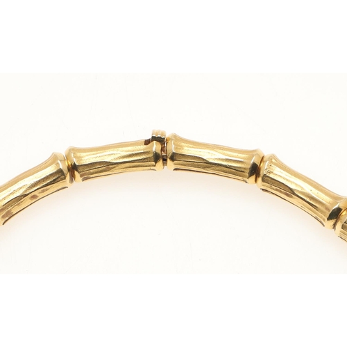 259 - A DIAMOND AND 18CT GOLD COLLAR NECKLACE. formed with textured links of bamboo design, with three dia... 