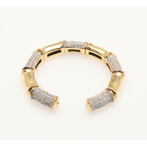 260 - A DIAMOND AND GOLD OPEN BANGLE. formed with alternate diamond set and plain gold sections, internal ... 